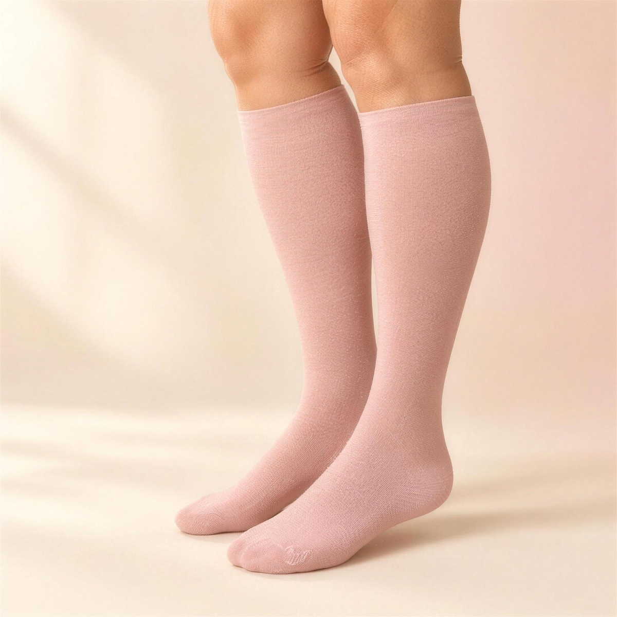 Legs in blush HugStep compression socks, studio