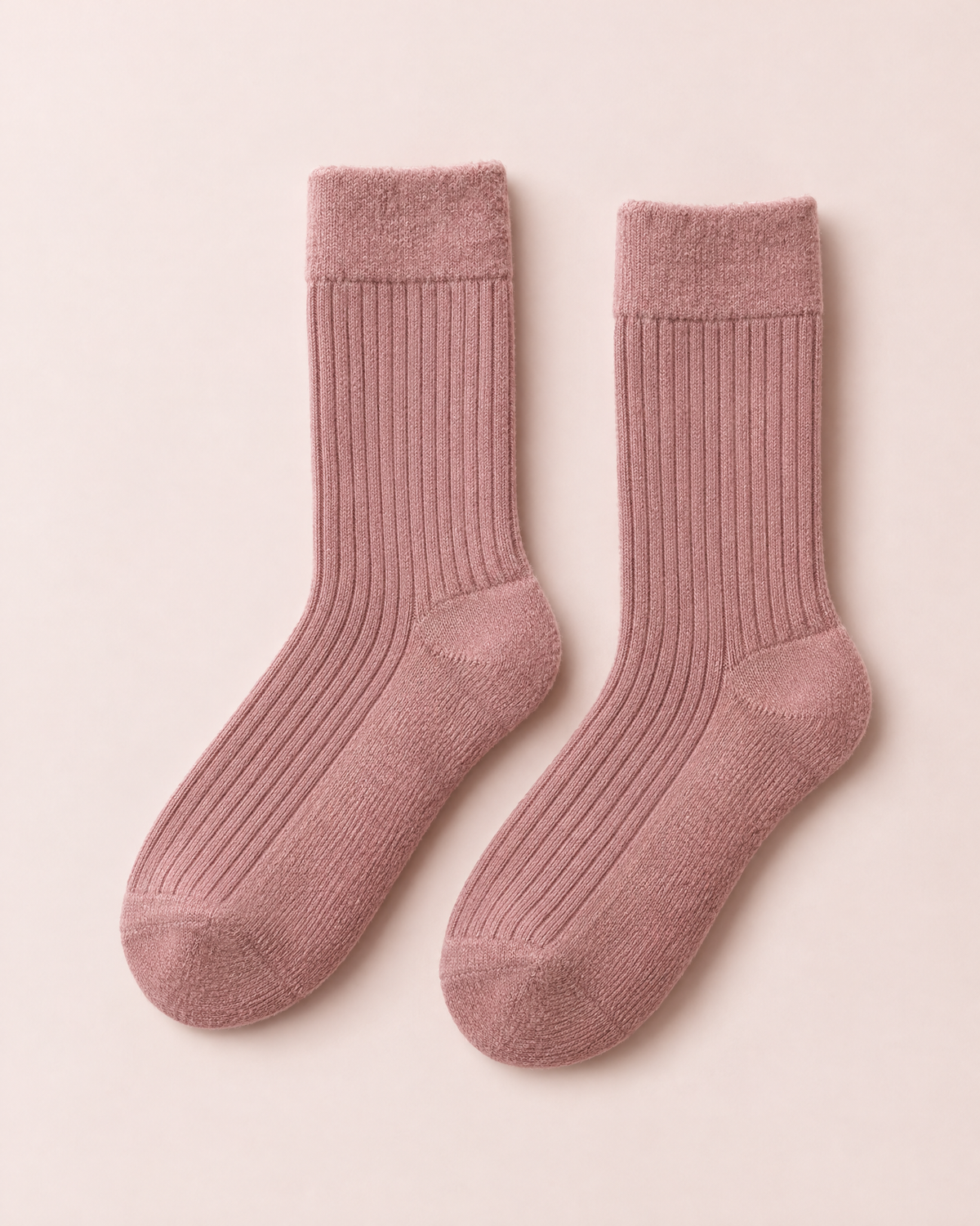 A pair of rose ribbed socks laid flat
