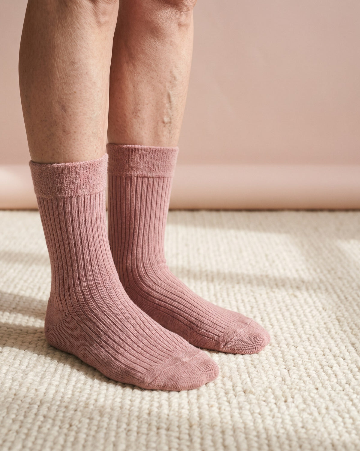 HugStep dusty rose socks worn on the feet