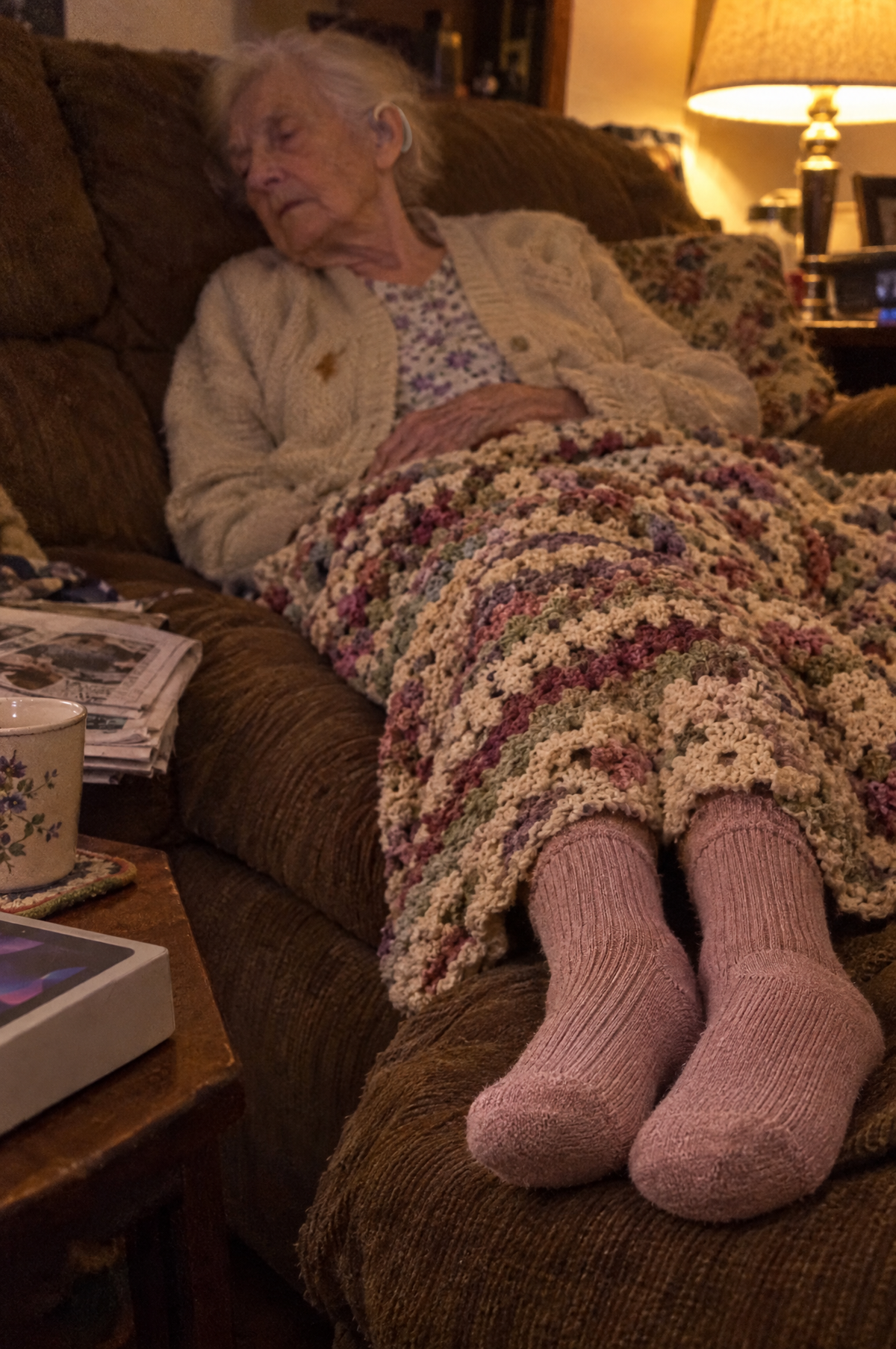 Woman dozing on the sofa under a blanket in HugStep socks