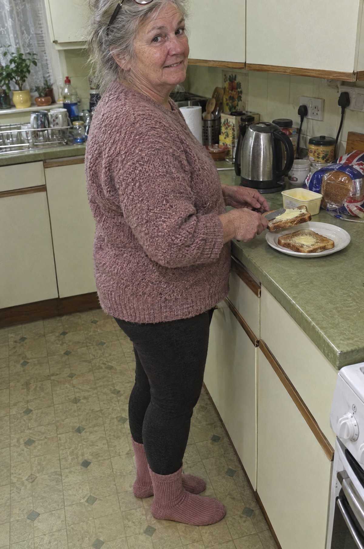 Woman making toast in her kitchen in HugStep socks
